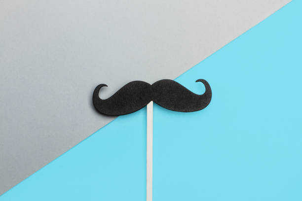 istock A black mustache on a blue and gray background 1186074189