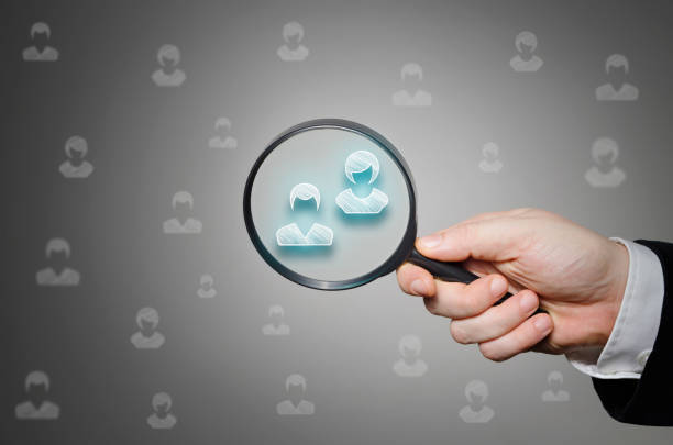 Find the right people. Human resources management, recruitment business hiring or choosing partner concept with hand held magnifying glass.