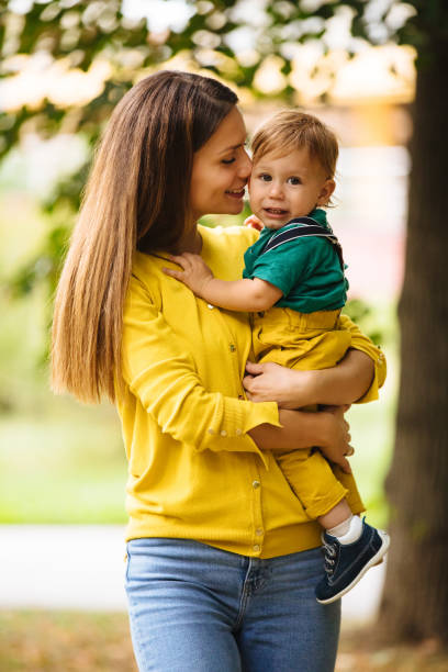 istock Beautiful young mother holding her baby boy 1186076232