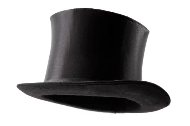 Stylish attire, vintage men fashion and magic show conceptual idea with 3/4 angle on Victorian black top hat with clipping path cutout in ghost mannequin technique isolated on white background