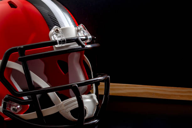 istock Tactical training, planning for a tough competition and studying the rival team concept theme with close up on a American football helmet next to a blank blackboard with copy space 1186077439