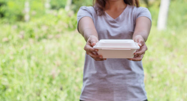 istock Hand girl holding foam boxes rice. 1186077955