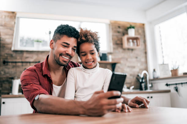 istock Happy father and daughter making a selfie in the kitchen. 1186078757