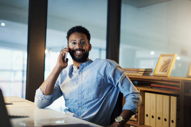 istock Making some calls to his international clients 1186079126