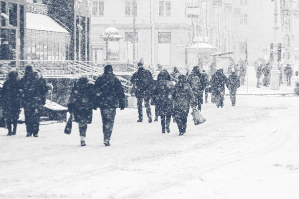 istock People walking on an icy snowy pavement 1186080608