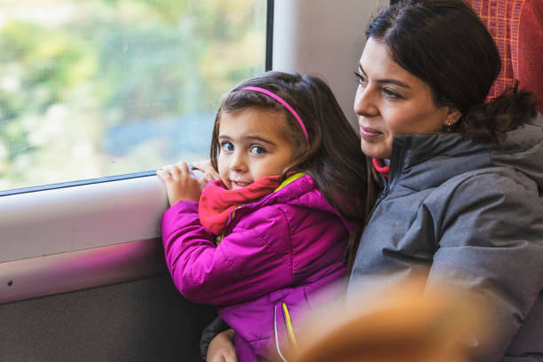 istock Mother and daughter enjoying the train ride 1186081202