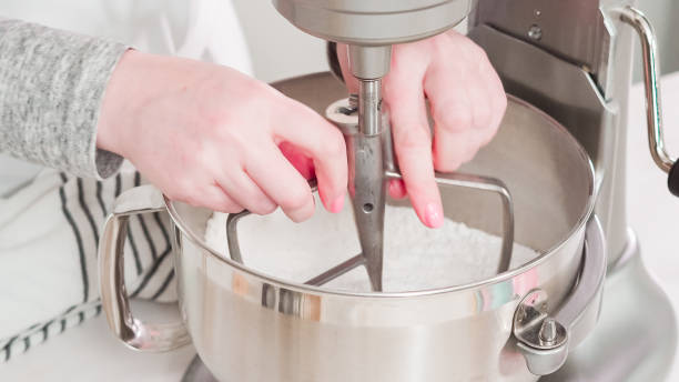 istock Mixing royal icing to decorate Easter sugar cookeis. 1186081655