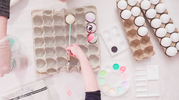 istock Little girl painting craft Easter eggs 1186083061