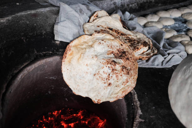 istock Making bread in tandoor oven 1186083414