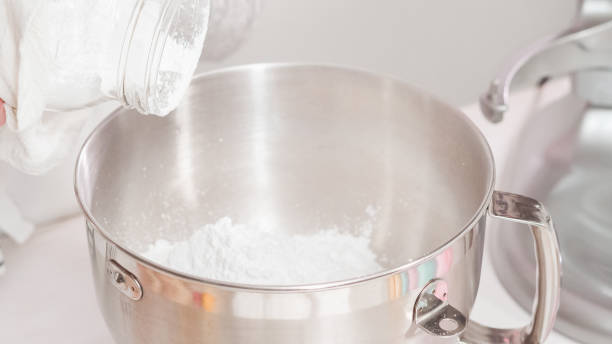 istock Mixing royal icing to decorate Easter sugar cookeis. 1186083504