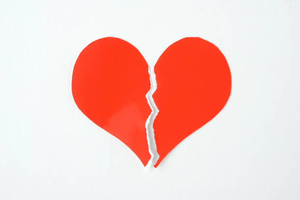 istock Broken heart-shaped paper on white background 1186083633