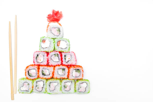 Funny edible Christmas tree made from sushi, creative idea for japanese restaurant on white background. New Year food background top view . holiday, celebration, food art concept. Copyspace
