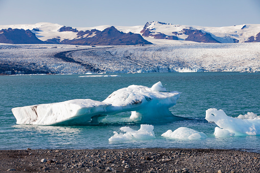 Icebergs on Jokulsarlon glacier lagoon with Vatnajokull glacier in the background