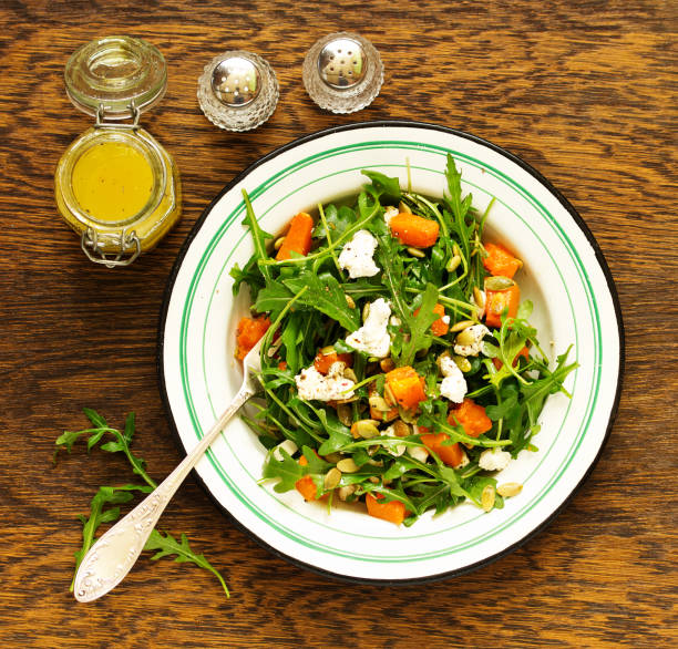 salad with pumpkin, feta and arugula. . Selective focus