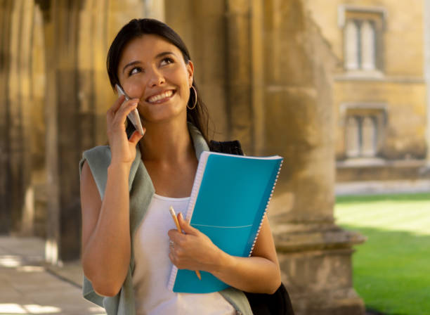istock Female student talking on the phone at the university 1186089432