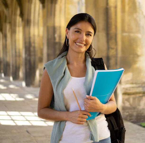 istock Beautiful female student looking happy at the university 1186089440