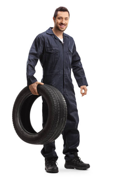 istock Mechanic smiling and holding a tire 1186089452