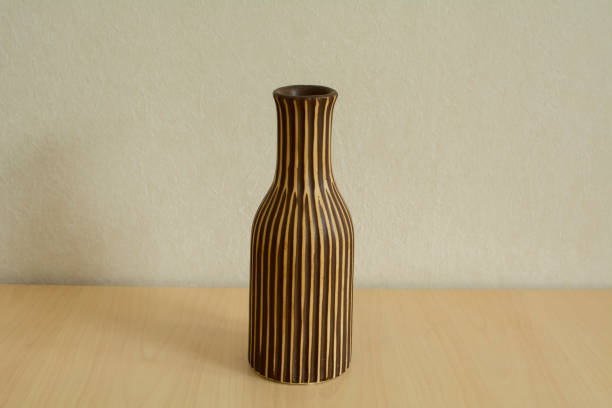 istock Flower vase on a table by the wall 1186089562