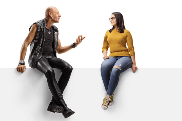 Punker sitting on a panel with a young female and talking