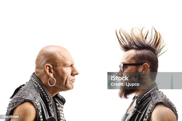Young Punker With A Mohawk And An Older Bald Punker Looking At Eachother Stock Photo - Download Image Now