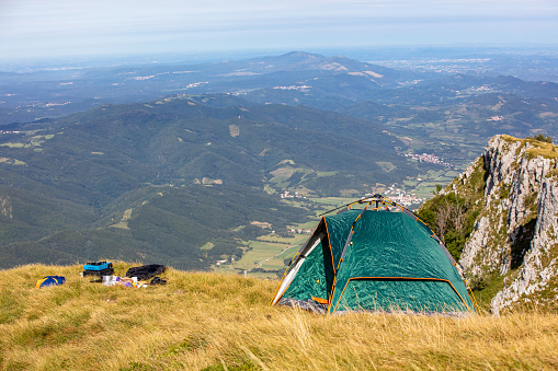 Landscape with view of a camping tent near the edge of a majestic cliff, Nanos, Slovenia