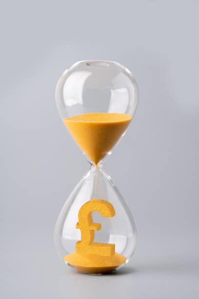 istock Sand clock for business concept and currency exchange 1186093510