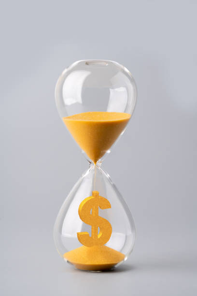 istock Sand clock for business concept and currency exchange 1186093513