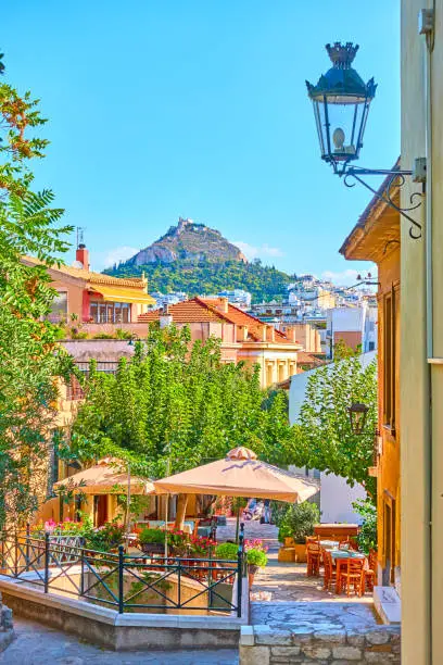 View of street in Plaka district in the old town of Athens, Greece - picturesque cityscape with city skyline