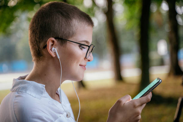 istock View of woman using smart phone and smiling 1186094708
