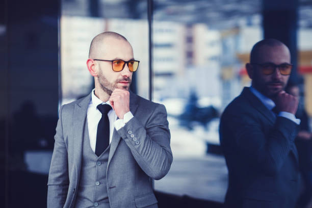 istock Successful man in gray suit looking away 1186095409