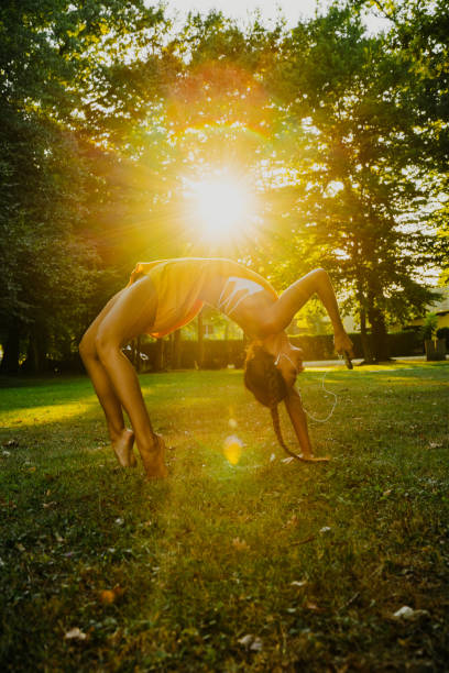 View of woman making exercise and using smart phone in park