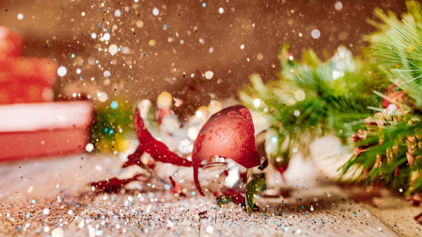 Glitter being scattered over a broken Christmas ball