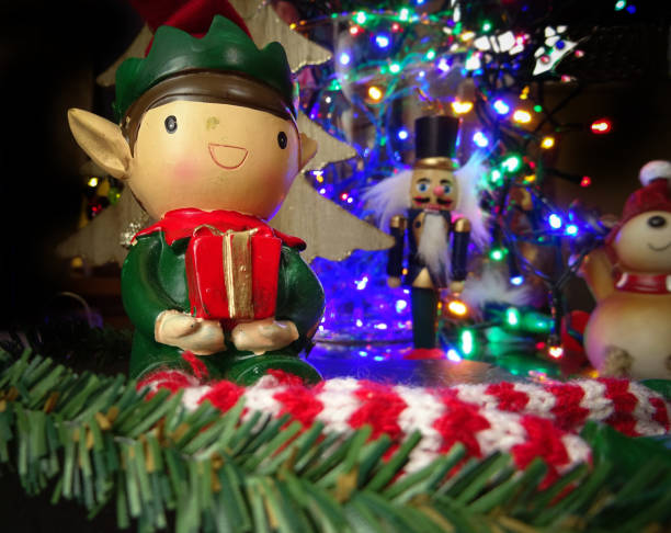 istock Old Christmas elf decoration with festive lights 1186098642