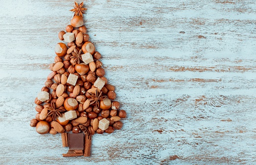 Christmas tree made of nuts, spices and dried oranges. Viewed from above.
