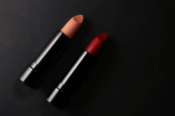 Lipstick. Fashion Colorful Lipsticks over black background. Lipstick tints palette, Professional Makeup and Beauty. Beautiful Make-up concept. Lipgloss. Lipsticks closeup