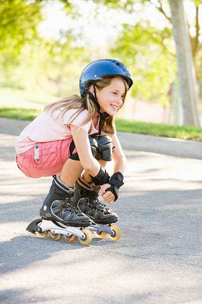 Cute little girl is practicing roller skating