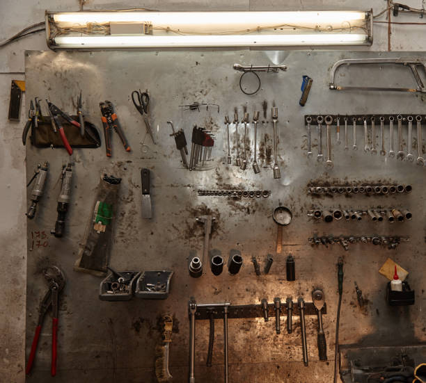 istock Workshop scene. Image of old tools hanging on wall in workshop. Vintage retro garage style 1186101408