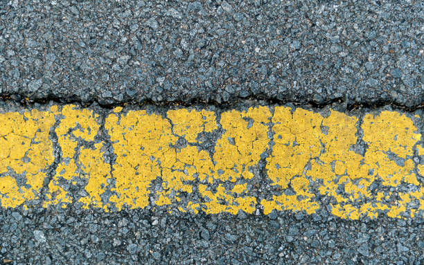 27th street, Long Island City, Queens, New York, USA - August 13th 2023:  View down a street with a warning for a speed bump at night time and a woman crossing the street