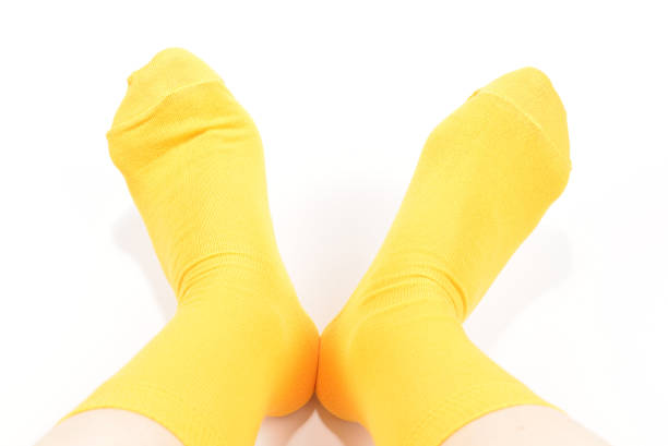 istock Yellow socks on woman foot isolated on white background. 1186102003
