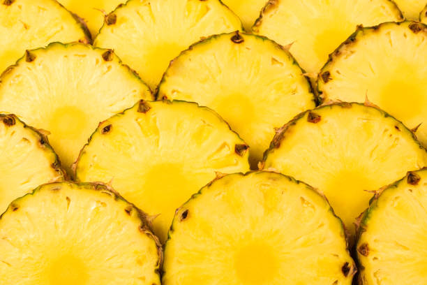istock Pineapple juicy yellow slices background. Top view. 1186102042