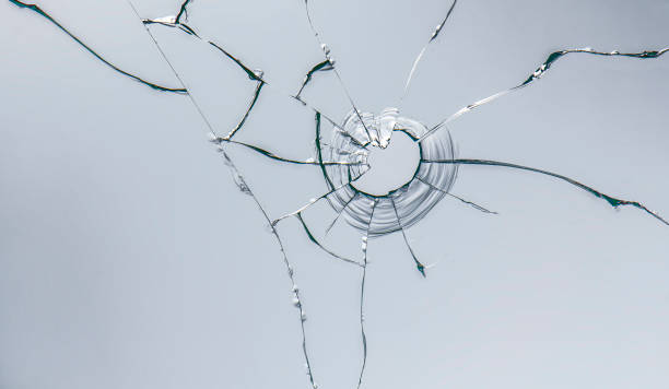 istock glass crack after window destruction on soft blue background 1186102816