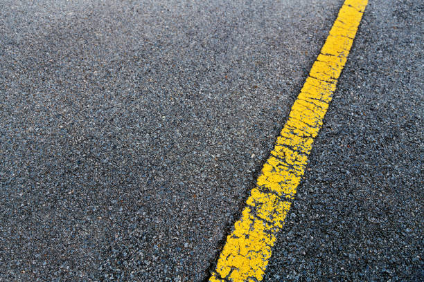 Yellow lane on asphalt road background.