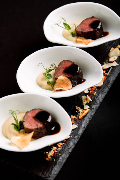 istock Tuna canapes with red wine sauce and mashed asparagus with beans 1186103177