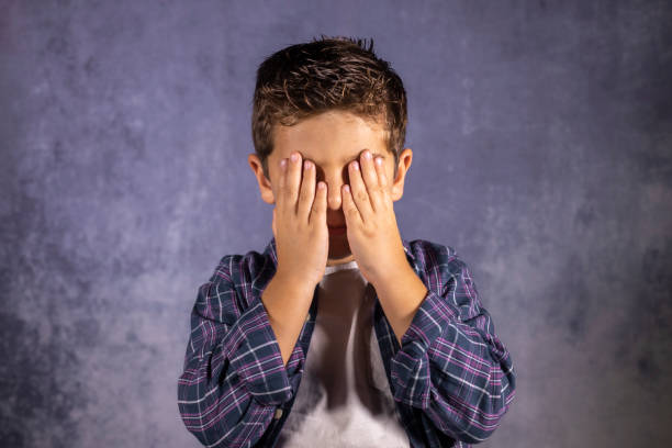 istock Little child covering his eyes with his hands 1186105263