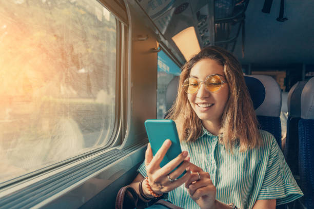istock Happy Asian girl using transport application on smartphone while travelling by high speed train 1186106502