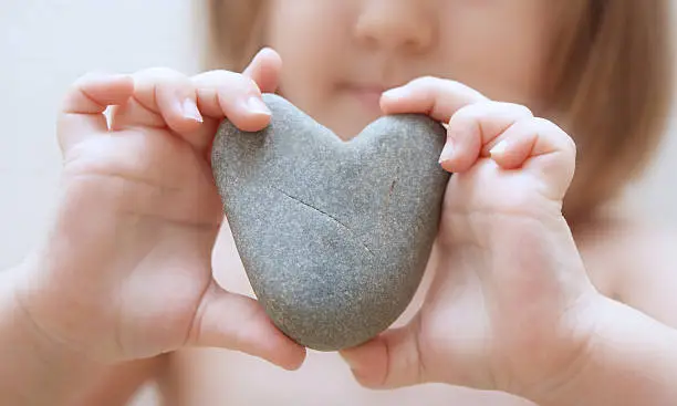 Photo of Child's hands hold heart