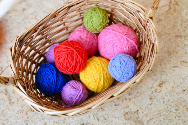 istock wicker basket with multicolored bright balls of wool yarn for knitting 1186109932