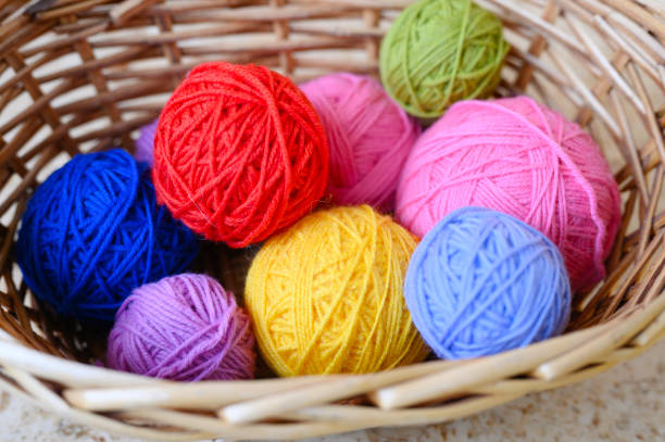 istock wicker basket with multicolored bright balls of wool yarn for knitting 1186109942