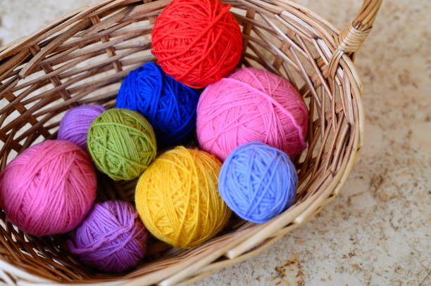 istock wicker basket with multicolored bright balls of wool yarn for knitting 1186109973