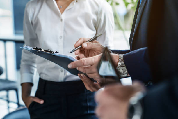 istock Close up shot of business colleagues discussing over report document at work 1186111181